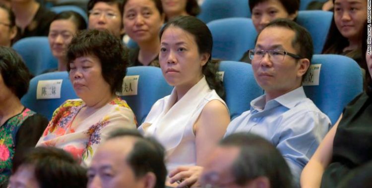 --FILE--Yang Huiyan, center, Vice Chairwoman of Chinese real estate developer Country Garden, attends an alumni conference in Foshan city, south China's Guangdong province, 26 June 2016. Yang Huiyan, vice-chairwoman of Country Garden, has been crowned China's richest woman with a fortune of 126.9 billion yuan ($18.68 billion), according to the Forbes Richest Women in China 2019 list released by Forbes China. Wu Yajun, chairwoman of Longfor Properties, ranked second with a personal wealth of 60.75 billion yuan, followed by Chen Lihua, chairwoman of Fu Wah International Group, with 39.15 billion yuan.  (Imaginechina via AP Images)