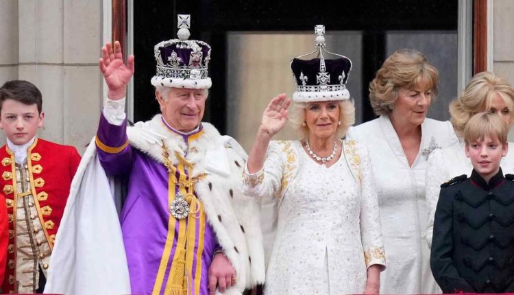 Britain's King Charles III and Queen Camilla wave to the crowds from the balcony of Buckingham Palace after their coronation ceremony in London on May 6.