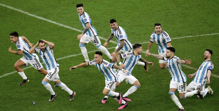 Argentina's players celebrate their victory at the end of the World Cup final match.